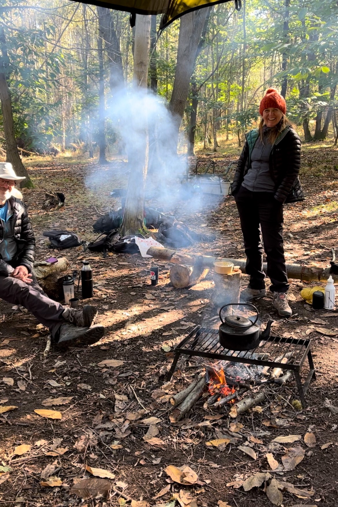People around a campfire in a woodland